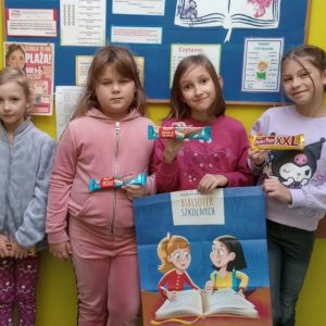 Otwórz zdjęcie - Uśmiechnięte dziewczynki trzymają w rękach plakat.